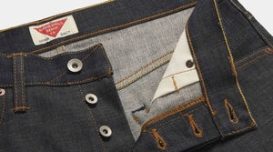 Close up of raw indigo denim jeans waistband. Featuring Hawksmill Denim Co new label. Shows quality of details including Union Special chain stitch, pockets, rivets etc